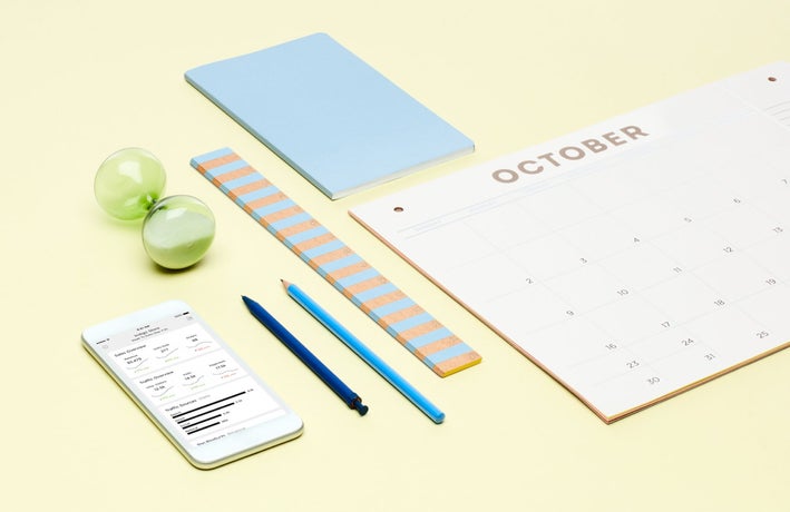 Yellow background with calendar, stationary supplies, and a phone showing online sales information