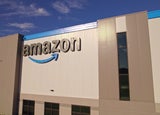 Toronto, Ontario, Canada - September 11, 2022: Amazon warehouse building headquarter and close-up logo of the company at golden hour evening. Technology company developed international e-commerce.