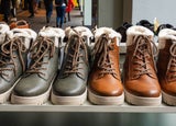 a line up of identical looking black and brown boots