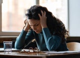 a woman struggling with stress at her desk