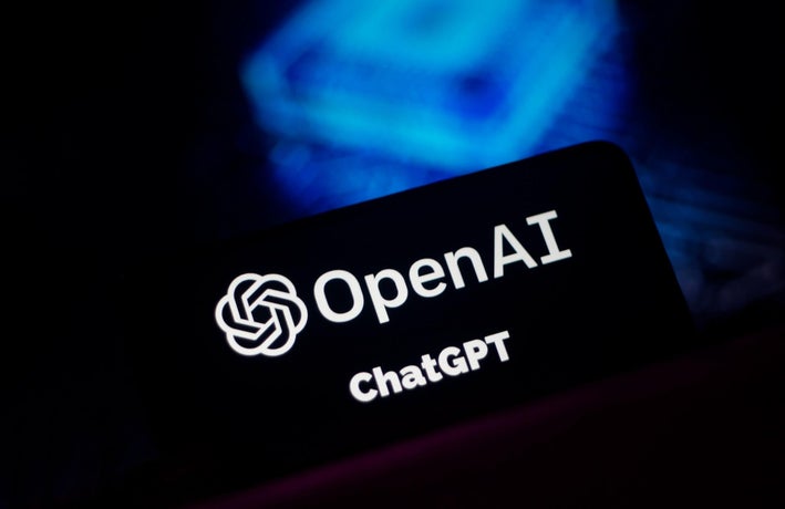 A black card displaying the OpenAI logo with a blue backdrop.