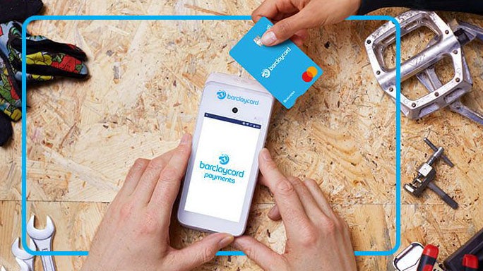 Marketing image of a payment card being tapped on a Barclaycard Smartpay Touch