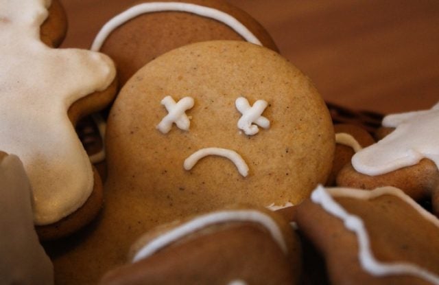 gingerbread cookie with a sad face drawn in icing