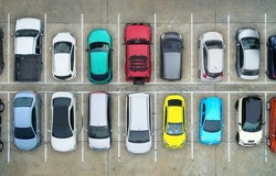 Aerial view of amulti coloured cars parked in bays