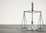 silver balancing scales on a desk